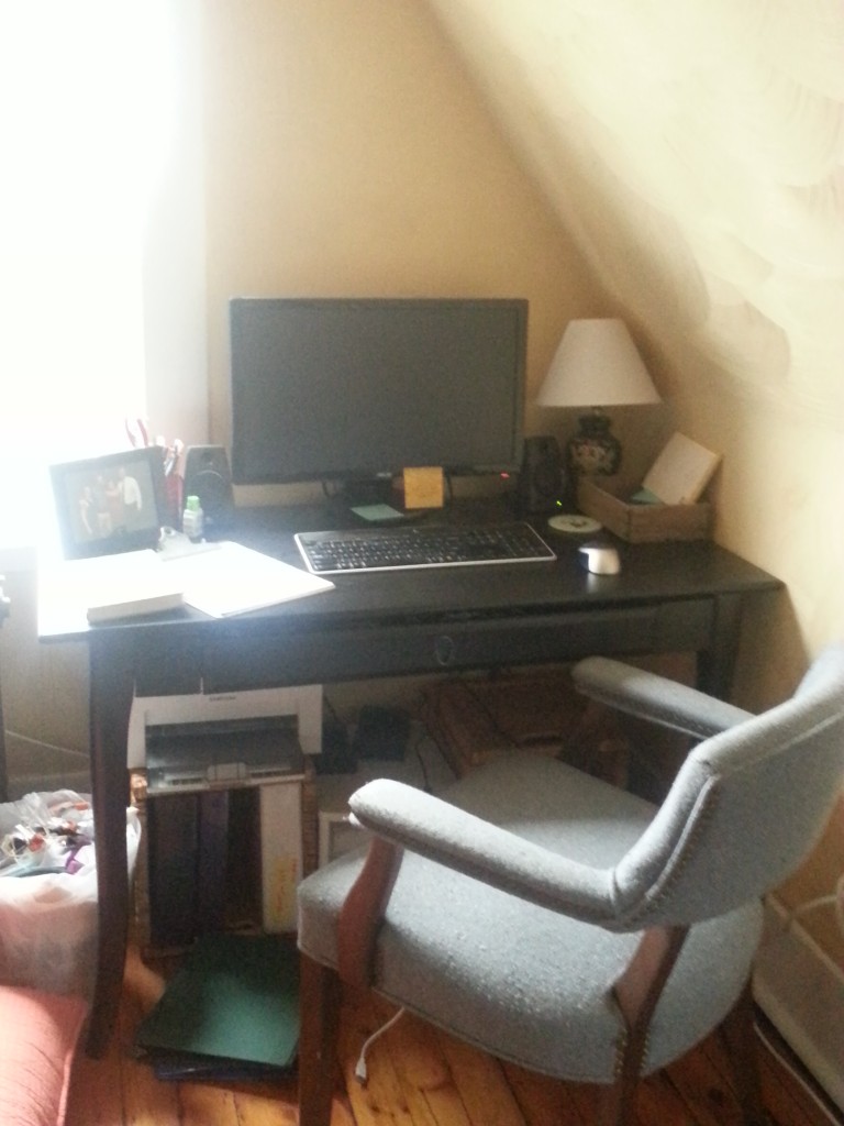 My "real" desk -- comfortable chair purchased for $15 at a thrift store, solar wireless keyboard (an investment, but so worth it), and most importantly, the external 23" monitor.